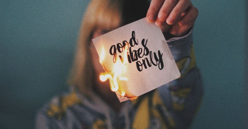 Paper Finish - Unrecognizable female showing burning paper with written inscription and bright flame on blurred background